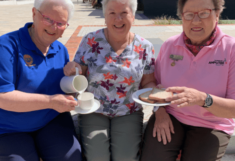 Three ladies sitting together with the Devonport Mayor Annette Rockliff in the middle pretending to serve them breakfast. The photo is to promote the Devonport volunteers breakfast being held on Monday 6 December.