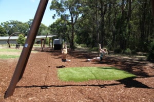 Image shows two teenagers on a flying fox feet and legs in the air