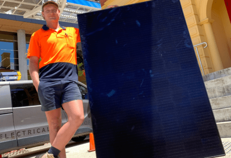 DES Electrical Contractors employee Joseph Robertson with one of the 148 solar panels that are currently being installed on the paranaple arts centre roof as part of Devonport City Council’s strategic goal to live lightly on the environment.