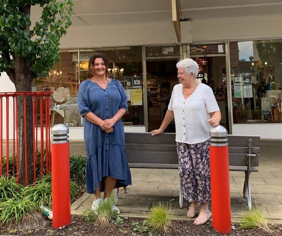 Two women standing outside a Devonport shop.