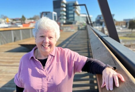 A woman standing on the elevated walkway in Devonport.