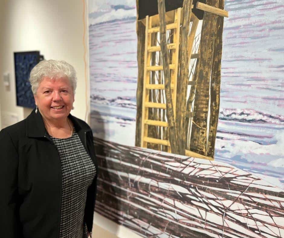 A woman standing in front of art work at the Devonport Regional Gallery. The woman is Devonport Mayor Annette Rockliff.