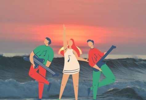 Image shows three members of a band in front of the ocean